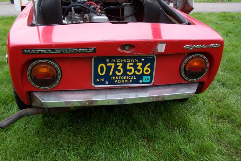 a red sports car parked on a lawn