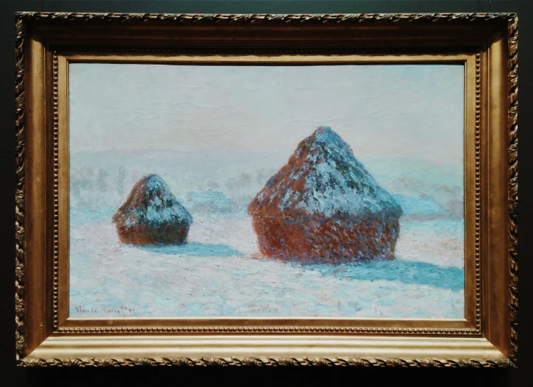a painting of two big hay stacks in the snow