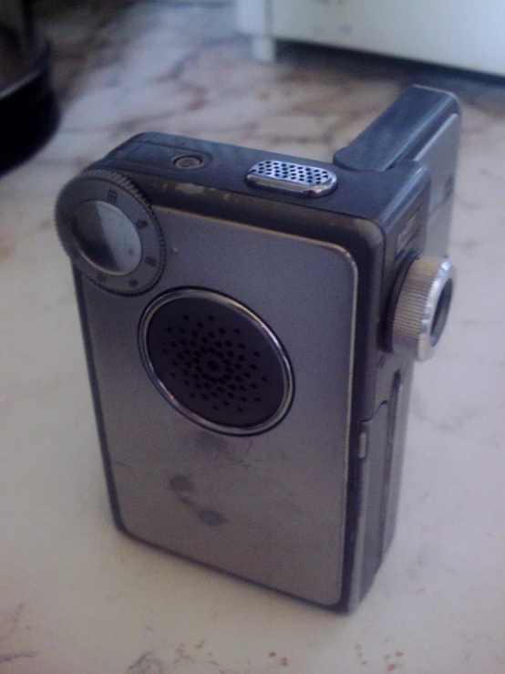 an old radio sitting on a table with a pair of headphones attached to it