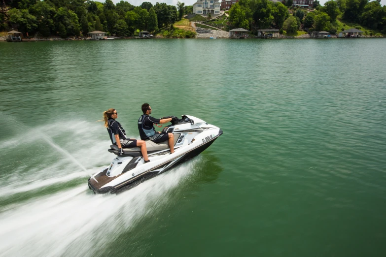 a couple are in their jet skis on the water