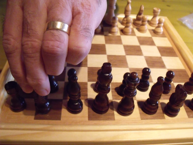 someone playing a chess game with pieces placed on a chessboard