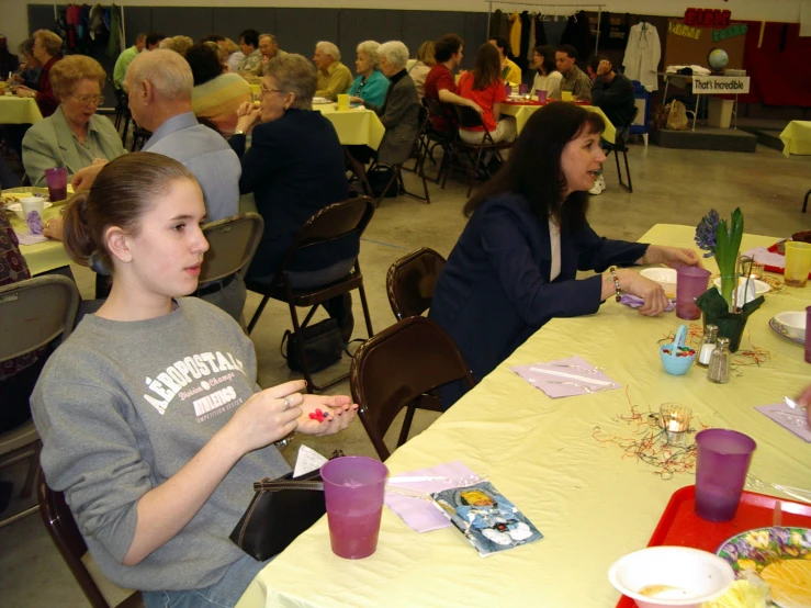 two girls sitting at a table having a conversation