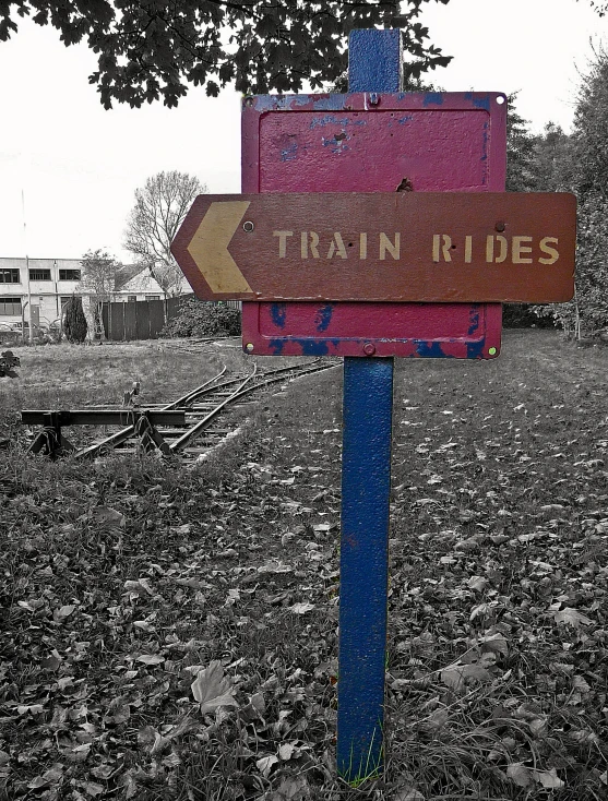 a road sign points the way to a train ride