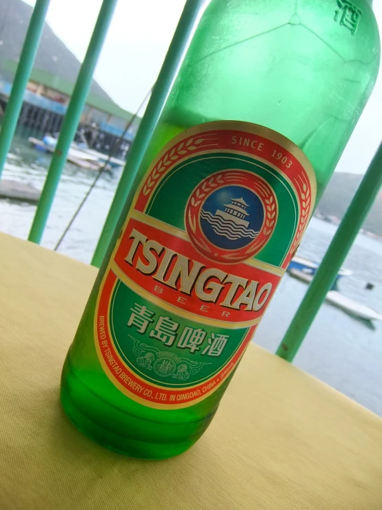 a green bottle with chinese writing on it
