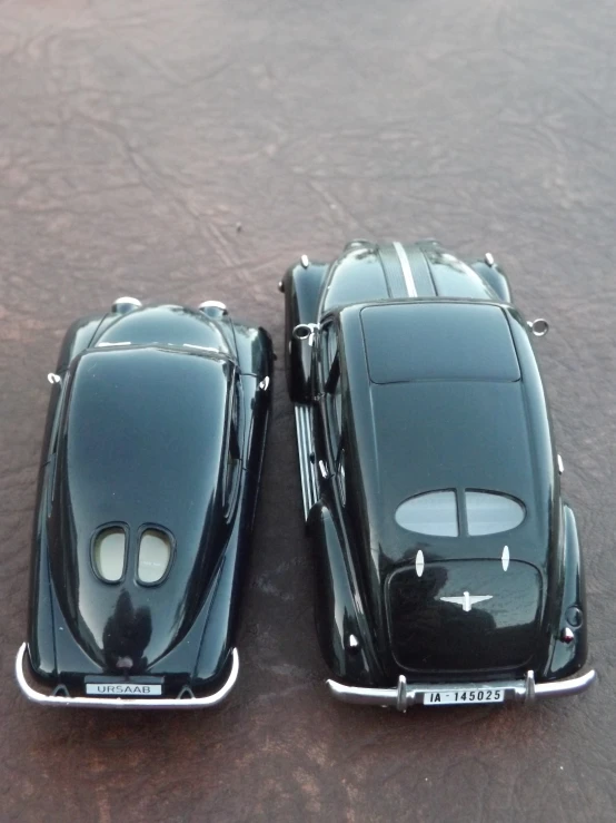 two toy cars are shown parked on a table