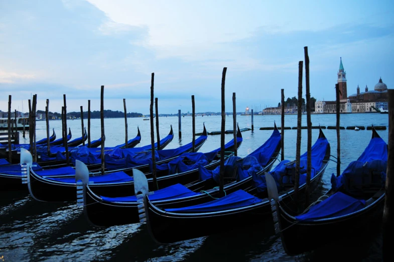 the boats are lined up in front of a large building