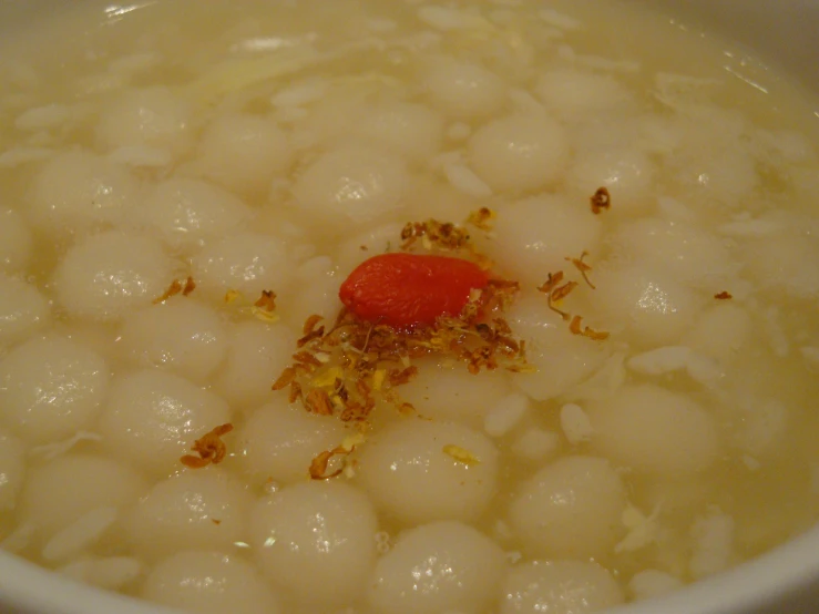 a white bowl filled with a food on top of it