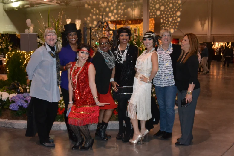 several ladies posing for a picture with some fancy outfits