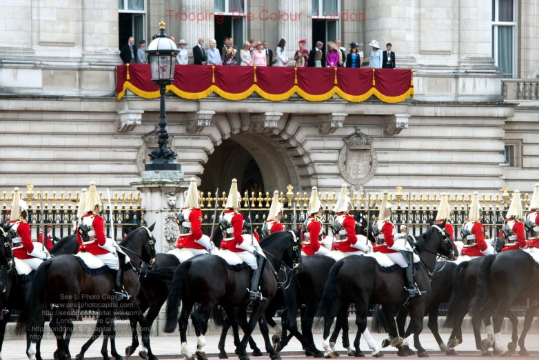 a crowd of people in uniform on horses