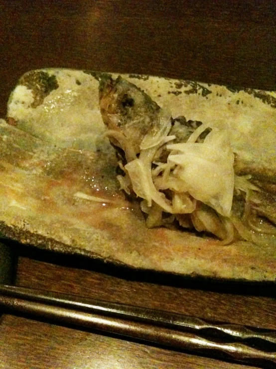 a dish filled with noodles on a wooden table