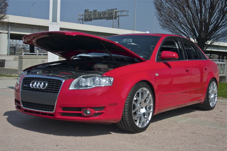 red audi s3 with hood open in parking lot