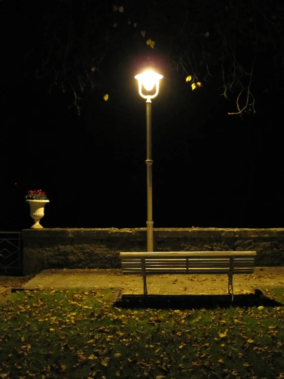 park bench in the evening light shines on the wall