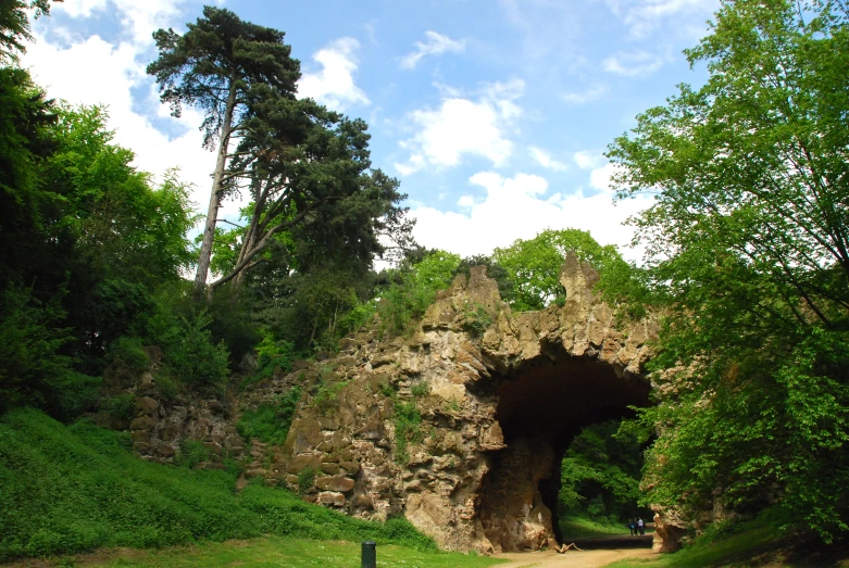 an outdoor tunnel at the end of a dirt road