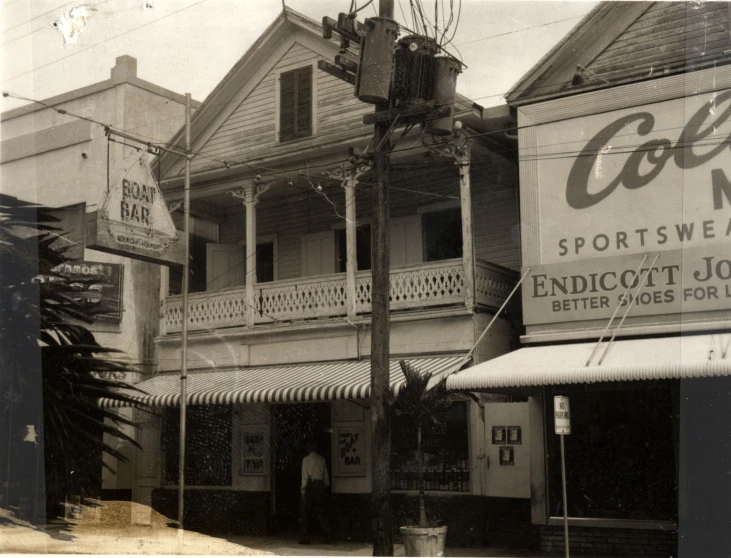 an old fashioned black and white po of a building with a sign