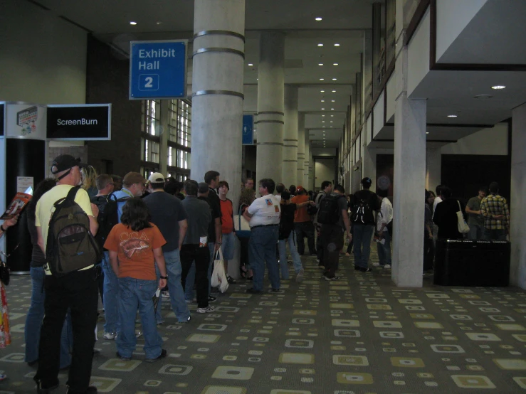 people waiting in line at a busy airport