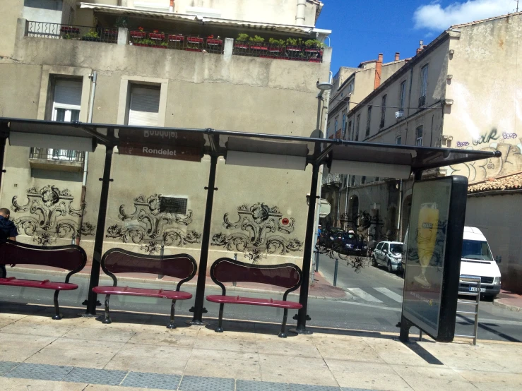 the bench is in front of the bus stop