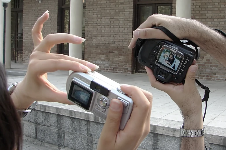 two people taking pos of the back of a building