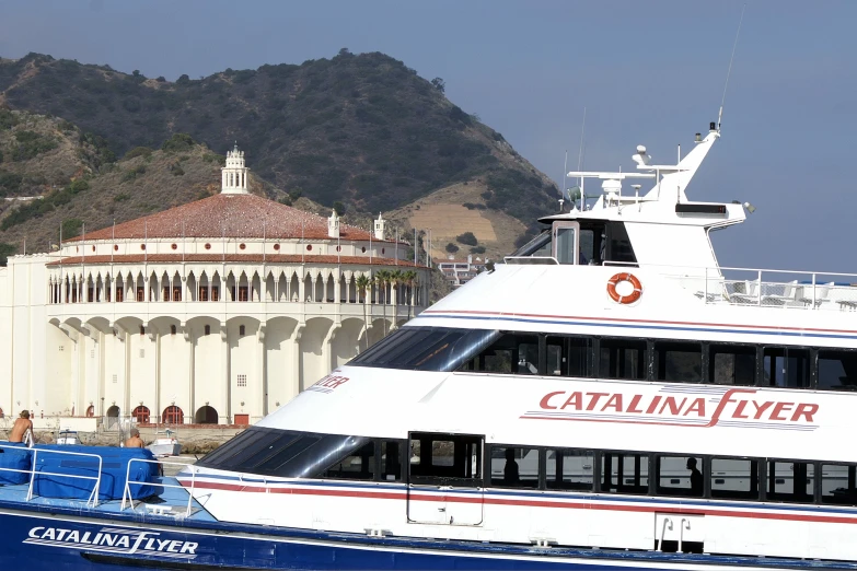 a large cruise boat is in the water near buildings