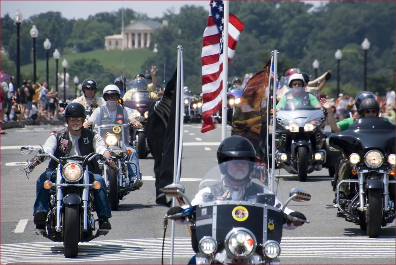 several motorcycles with flag and officer on back