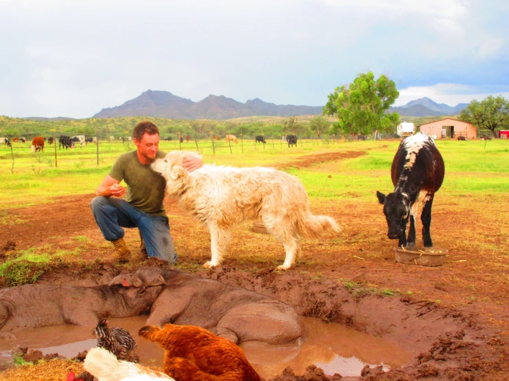 a man and his dog in front of a pond of water