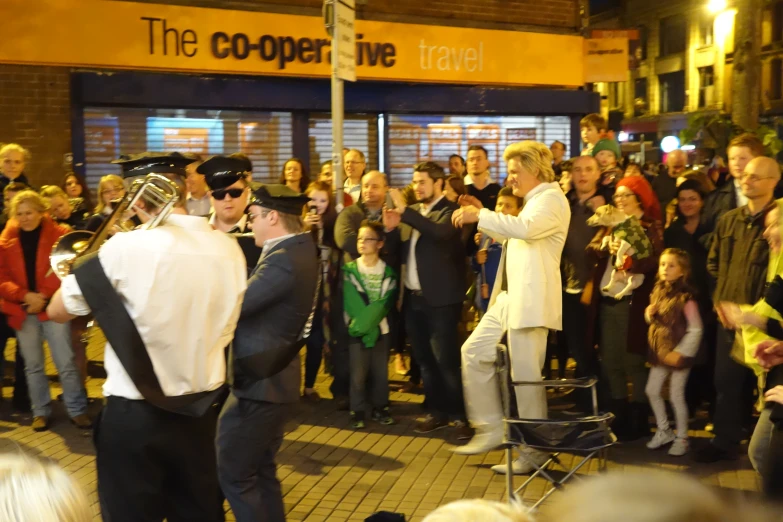 a crowd of people watching two police officers stand next to each other