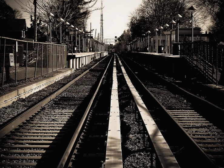 an image of black and white railroad tracks