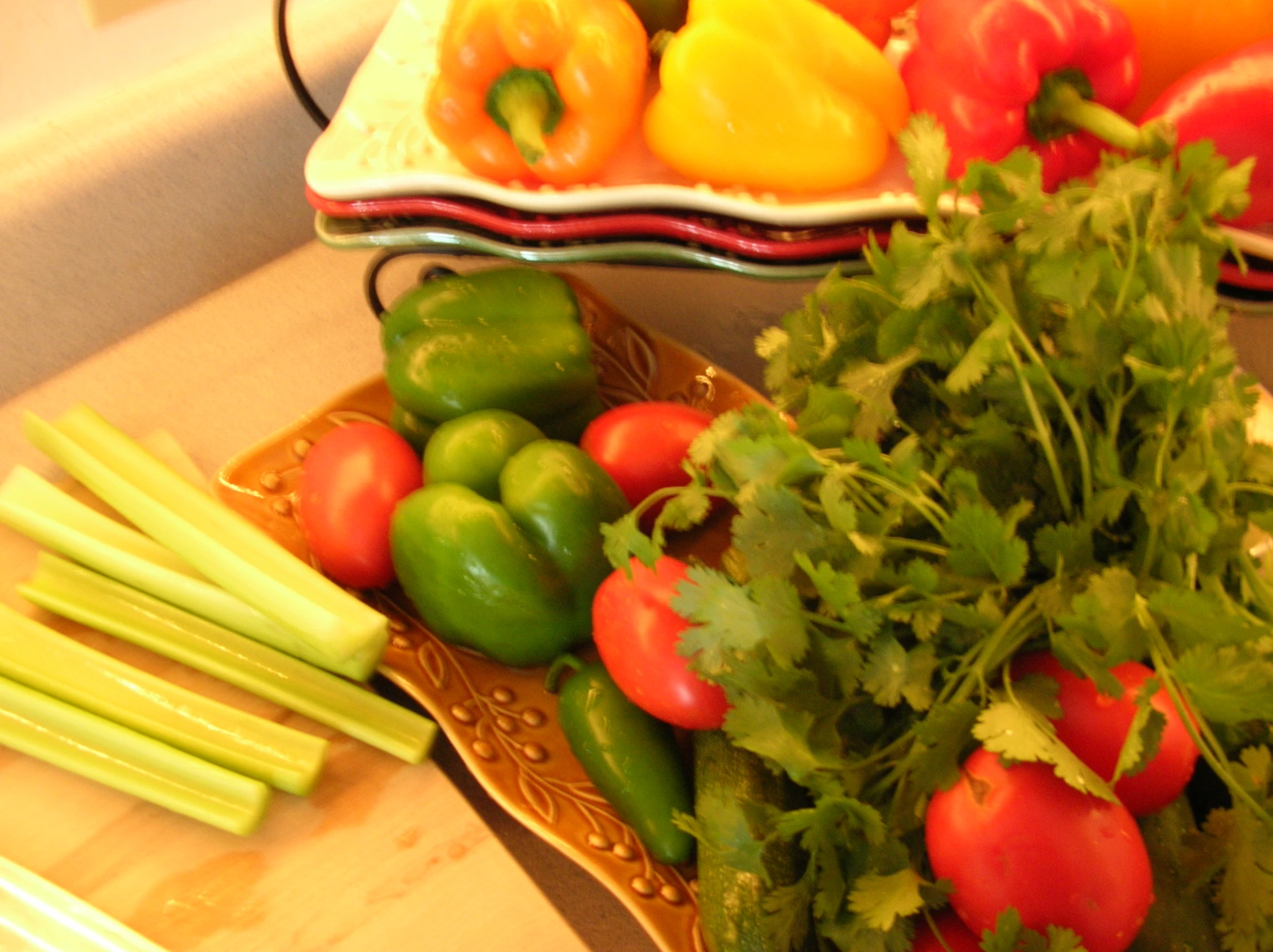 many different types of vegetables sitting on some plates