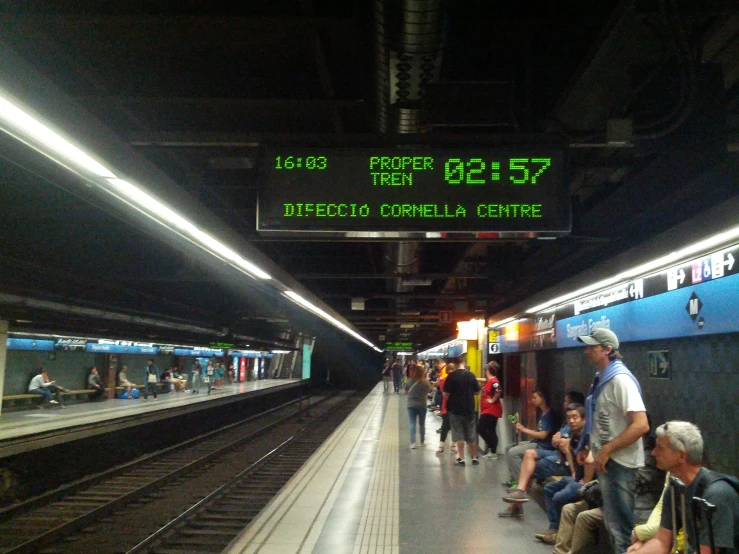 people waiting for the subway to arrive in a station