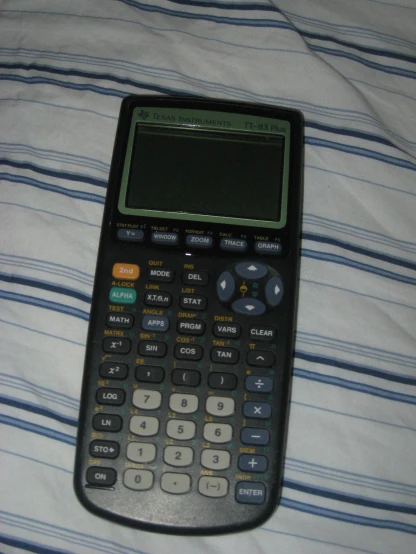 a calculator that is laying on a sheet