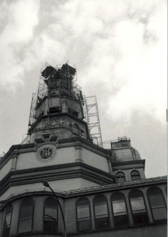 a tower is shown with clock and scaffoldings on the side