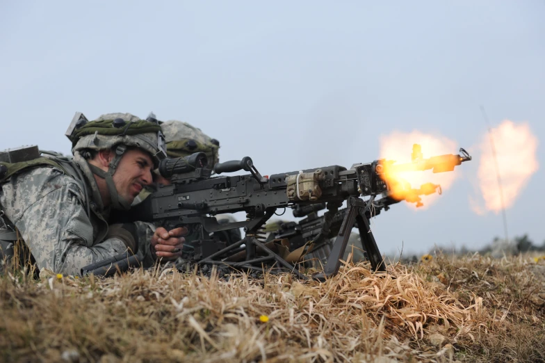 a soldier with the american army aiming at another machine gun