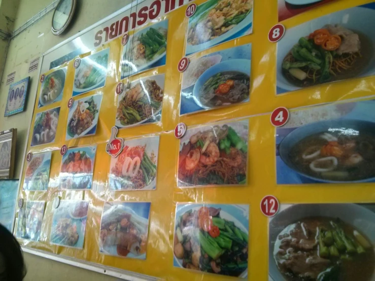 a menu with pictures on it on the wall