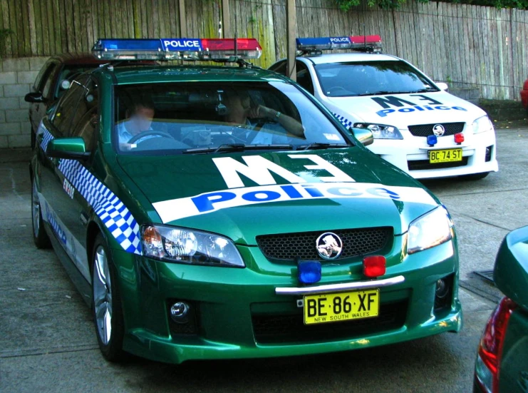 there are three different police cars on this street