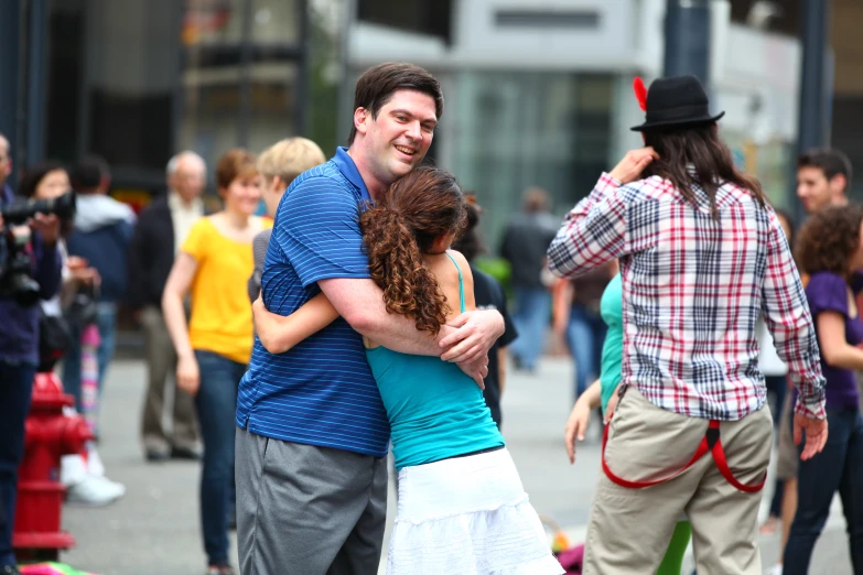 a man hugging a  as others look on