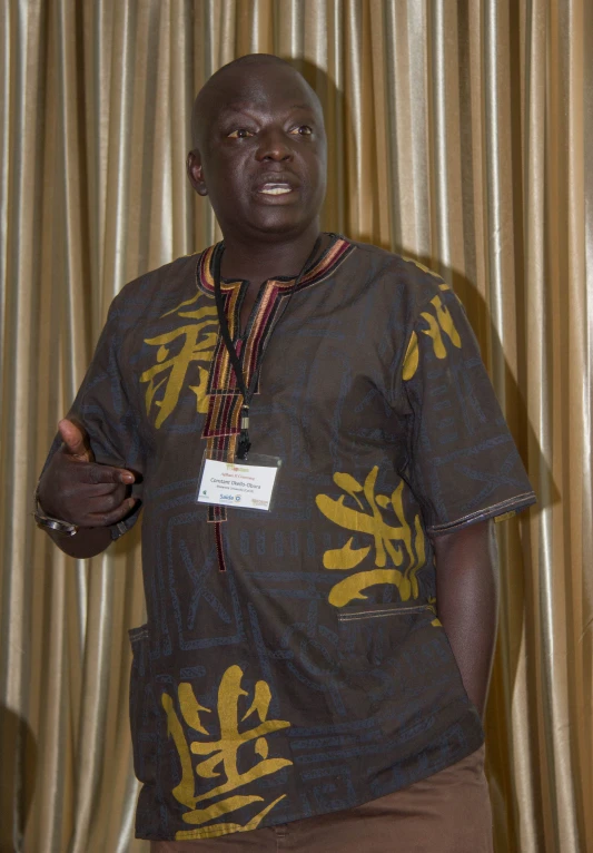 a man in a gray shirt with yellow flowers on it