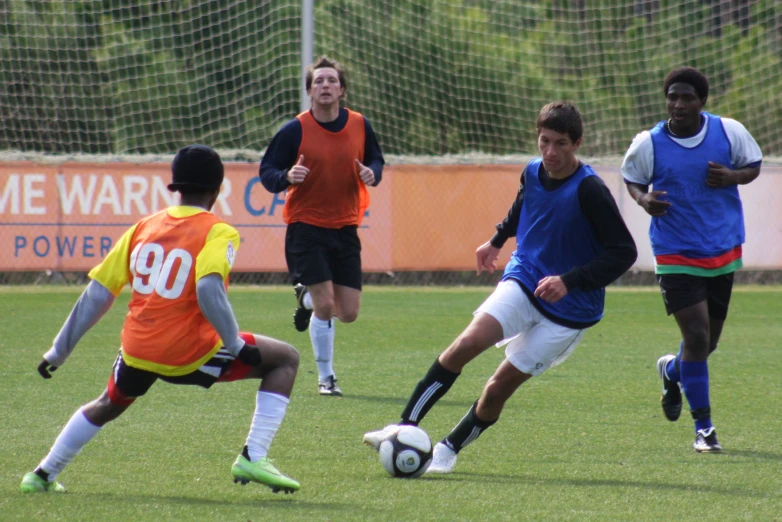 a group of young men playing soccer on a field