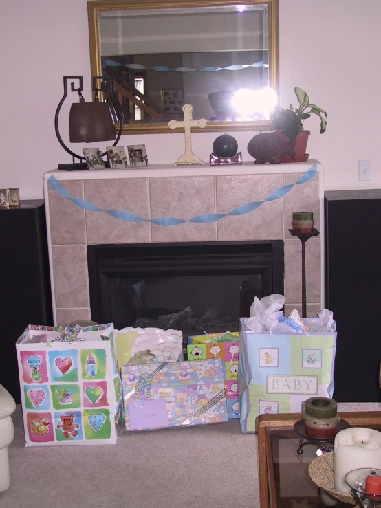 presents are sitting on the floor in front of a fireplace