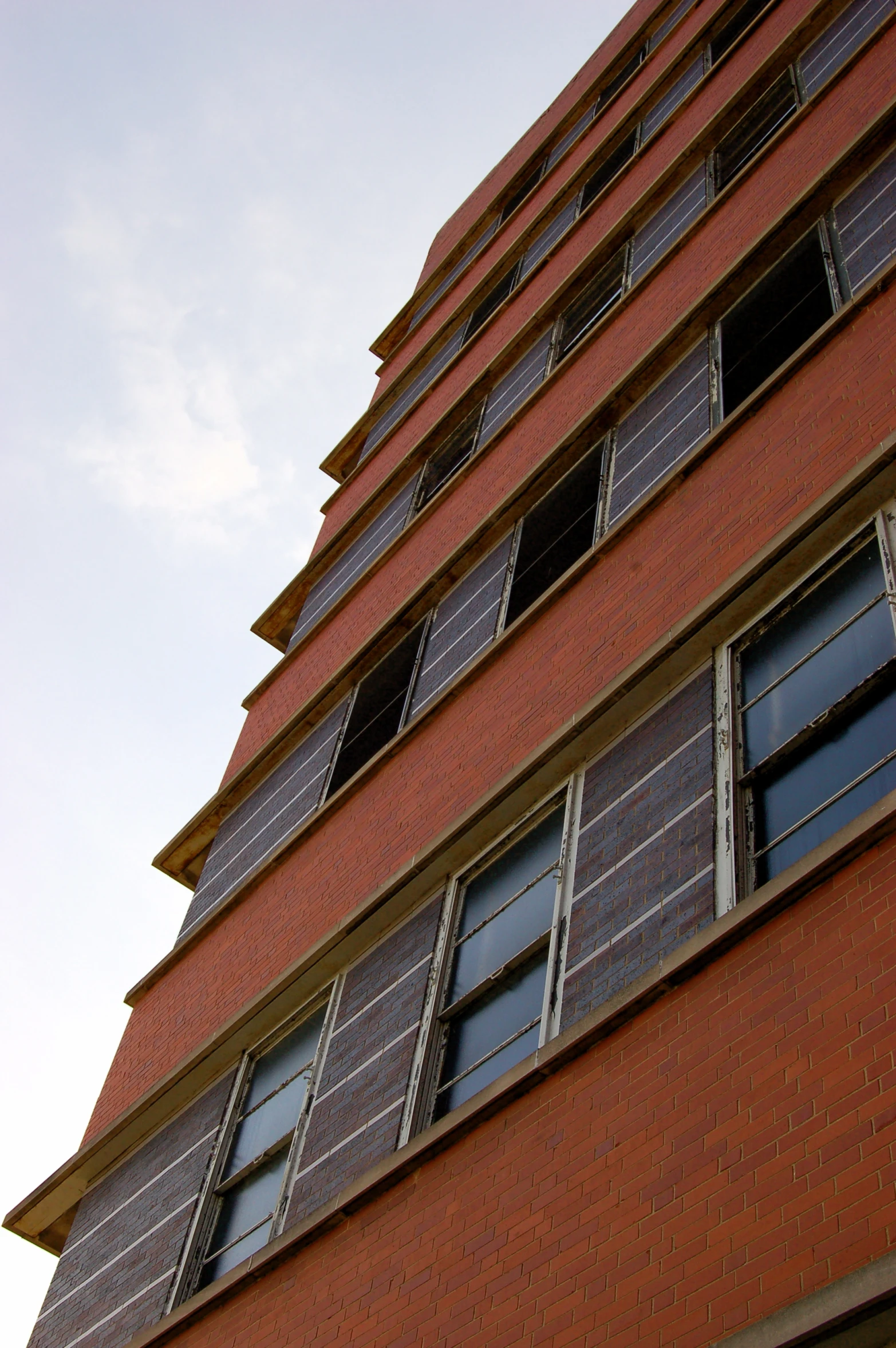 a brick building with windows and an umbrella