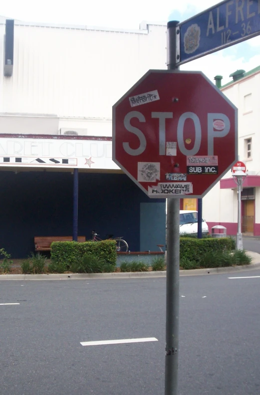 a stop sign is on the corner by a street