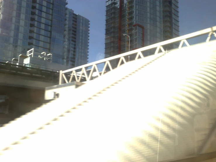 a rail bridge suspended over the top of tall buildings