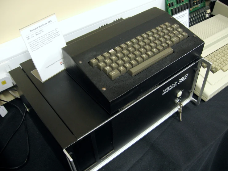 an old computer with an antique keyboard on top