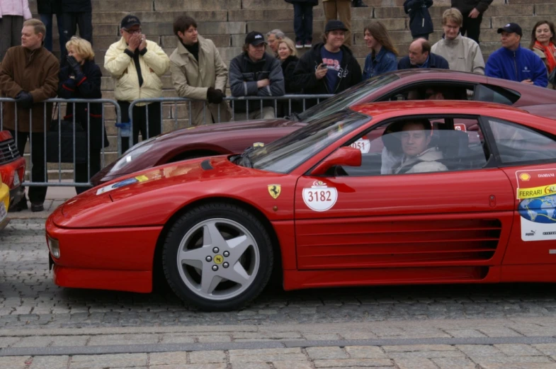 a ferrari sports car in front of the people