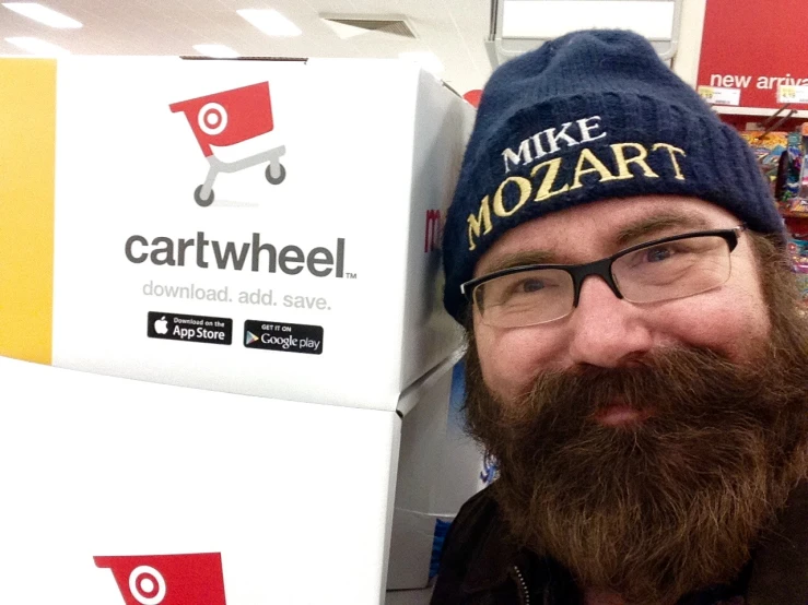 man smiling in front of cartwheel box at walmart