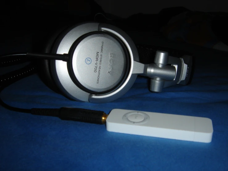an image of a silver electronic device that is plugged into a cord