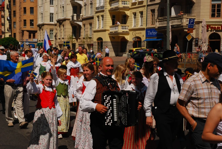 several people dressed up in costumes walking down a street