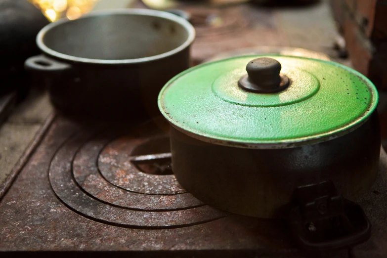 a pan and pan sitting on the stove with other pots