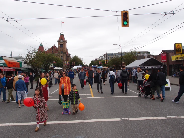 people walking in a group at a street market