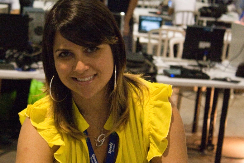 a woman wearing yellow smiling at the camera