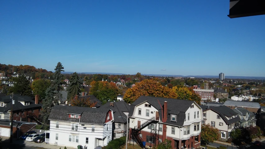 a clear blue sky shows the houses on a hill