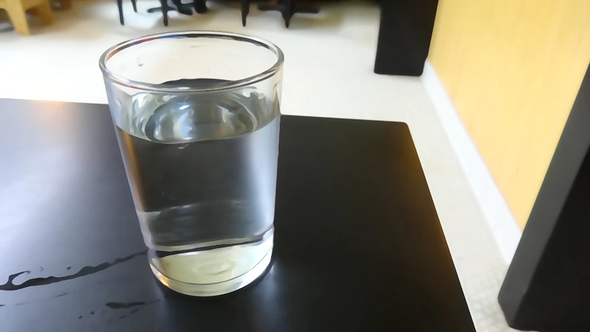 an empty glass sits on a small table